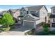 Charming two-story gray home featuring a spacious two-car garage and landscaped front yard at 7686 Grady Cir, Castle Rock, CO 80108