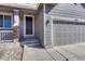 Close-up of the front door and two car garage highlighting the entry and architectural details at 7686 Grady Cir, Castle Rock, CO 80108