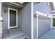 Home's front door entrance with a two-car garage and exterior lighting at 7686 Grady Cir, Castle Rock, CO 80108