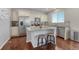 Bright kitchen with stainless steel appliances, an island with seating, and a decorative backsplash at 7686 Grady Cir, Castle Rock, CO 80108