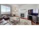 Cozy living room featuring a fireplace, comfortable seating, and hardwood floors at 7686 Grady Cir, Castle Rock, CO 80108