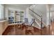 Cozy living room with built-in bookshelves, hardwood floors, and staircase at 7686 Grady Cir, Castle Rock, CO 80108