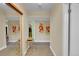 Hallway with mirrors and art leading to other rooms in the home at 3560 S Poplar St # 202, Denver, CO 80237