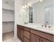 Bathroom features a double sink vanity with stone countertop and large mirror and walk-in closet at 20578 E 63Rd Ave, Aurora, CO 80019