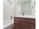Bathroom with white subway tile, tub, and wood vanity at 20578 E 63Rd Ave, Aurora, CO 80019