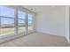 Bright bedroom boasts large windows, plush carpeting, and neutral walls for a serene, minimalist design at 20578 E 63Rd Ave, Aurora, CO 80019