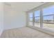 Bedroom featuring three large windows providing natural light and carpeted floor at 20578 E 63Rd Ave, Aurora, CO 80019