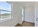 Bright entryway featuring wood floors, white trim, a large window, and ample natural light at 20578 E 63Rd Ave, Aurora, CO 80019