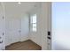 Bright entryway featuring wood floors, white trim, a window, and ample natural light at 20578 E 63Rd Ave, Aurora, CO 80019