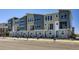 New townhome community showcasing modern exteriors with stone accents and gray siding in a contemporary design at 20578 E 63Rd Ave, Aurora, CO 80019