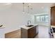Bright kitchen features an island with quartz countertops, stainless appliances, and pendant lighting at 20578 E 63Rd Ave, Aurora, CO 80019
