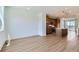 Open-concept living room flowing into a kitchen with wood cabinets and a kitchen island at 20578 E 63Rd Ave, Aurora, CO 80019