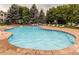 Large outdoor community pool with surrounding lounge chairs and mature trees at 8470 S Little Rock Way # 101, Highlands Ranch, CO 80126