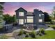 Inviting backyard with a stone patio, outdoor seating, and a modern fire pit at dusk at 7067 Gray Fox Ct, Highlands Ranch, CO 80130