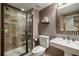 Bathroom with dark brown walls, a pedestal sink, a toilet, and a glass-door shower at 7067 Gray Fox Ct, Highlands Ranch, CO 80130