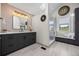 Modern bathroom featuring sleek vanity, stylish lighting, walk-in shower, and neutral tile flooring at 7067 Gray Fox Ct, Highlands Ranch, CO 80130