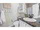 Cozy bathroom with a granite countertop vanity, decorative mirror, and a decorative shower curtain at 7067 Gray Fox Ct, Highlands Ranch, CO 80130