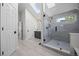 Bright bathroom features a tiled shower, skylight, and contemporary vanity with black hardware at 7067 Gray Fox Ct, Highlands Ranch, CO 80130