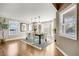 Bright dining room with a modern chandelier, hardwood floors, and a bay window at 7067 Gray Fox Ct, Highlands Ranch, CO 80130