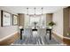 Charming dining room features a modern chandelier, hardwood floors, and a bay window at 7067 Gray Fox Ct, Highlands Ranch, CO 80130