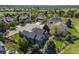 Aerial view of home with a stone patio, outdoor seating, and mature trees in a suburban neighborhood at 7067 Gray Fox Ct, Highlands Ranch, CO 80130