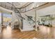Spacious foyer with hardwood floors, a staircase, and a view into the living spaces at 7067 Gray Fox Ct, Highlands Ranch, CO 80130