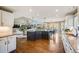 Open kitchen featuring granite counters, wooden floors, a kitchen island, and a view to the living room at 7067 Gray Fox Ct, Highlands Ranch, CO 80130