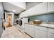 Well-equipped laundry room with ample counter space and storage at 7067 Gray Fox Ct, Highlands Ranch, CO 80130
