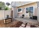 A patio and backyard area featuring a small table and convenient door to a storage closet and sliding glass door at 9713 W Chatfield Ave # F, Littleton, CO 80128