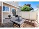 Outdoor patio with a modern fire pit and privacy fence creates a cozy entertainment space at 9713 W Chatfield Ave # F, Littleton, CO 80128