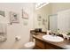 Bright bathroom with a single sink, vanity and decorative nautical artwork at 9713 W Chatfield Ave # F, Littleton, CO 80128