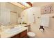 Cozy bathroom featuring a cream-colored vanity, neutral walls and a decorative bear-shaped toilet paper holder at 9713 W Chatfield Ave # F, Littleton, CO 80128