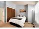 Comfortable bedroom with closet, and decorative painting above bed at 9713 W Chatfield Ave # F, Littleton, CO 80128