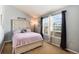 Cozy bedroom featuring plush bedding and a bright window view at 9713 W Chatfield Ave # F, Littleton, CO 80128