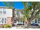Charming two-story townhome with brick accents and a cozy front porch area at 9713 W Chatfield Ave # F, Littleton, CO 80128