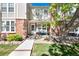 Charming townhome with brick accents, well-maintained landscaping, and a welcoming front porch seating area at 9713 W Chatfield Ave # F, Littleton, CO 80128