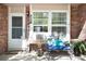Inviting front porch with a comfortable bench, charming decor, and a welcoming entrance at 9713 W Chatfield Ave # F, Littleton, CO 80128
