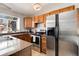 Kitchen featuring stainless steel appliances, granite countertops, and wooden cabinetry at 9713 W Chatfield Ave # F, Littleton, CO 80128