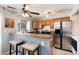 Kitchen area with barstool seating, stainless steel refrigerator, and tile flooring at 9713 W Chatfield Ave # F, Littleton, CO 80128