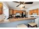 Open kitchen concept with granite counters, stainless appliances, and laundry area at 9713 W Chatfield Ave # F, Littleton, CO 80128