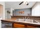 Kitchen area showcasing a stainless-steel sink, dishwasher, and brown granite countertops at 9713 W Chatfield Ave # F, Littleton, CO 80128