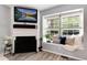Bright and cozy living room area with fireplace, a window seat and hardwood floors at 9713 W Chatfield Ave # F, Littleton, CO 80128