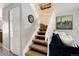 Carpeted staircase with white railing and blue sofa at base of stairs at 9713 W Chatfield Ave # F, Littleton, CO 80128