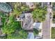 An aerial view shows the property with a lush backyard, patio, and driveway leading to the street at 13610 W Dakota Pl, Lakewood, CO 80228