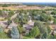Expansive aerial view of a tree-lined neighborhood, highlighting the spacious lots and the home's well-manicured landscape at 13610 W Dakota Pl, Lakewood, CO 80228