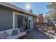 Well-lit back deck showcases a cozy seating area with modern furniture and a clear view of the home's exterior details at 13610 W Dakota Pl, Lakewood, CO 80228