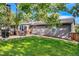 Expansive backyard showcasing a patio area with a grill and outdoor seating, ideal for relaxing and enjoying the green surroundings at 13610 W Dakota Pl, Lakewood, CO 80228