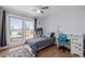 Cozy bedroom with natural light, hardwood flooring, a ceiling fan and white walls at 13610 W Dakota Pl, Lakewood, CO 80228
