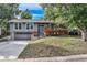 Charming gray home with a covered deck, attached garage and well-manicured lawn at 13610 W Dakota Pl, Lakewood, CO 80228