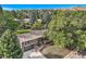 Stunning home with mature trees, a gray exterior and a covered deck at 13610 W Dakota Pl, Lakewood, CO 80228